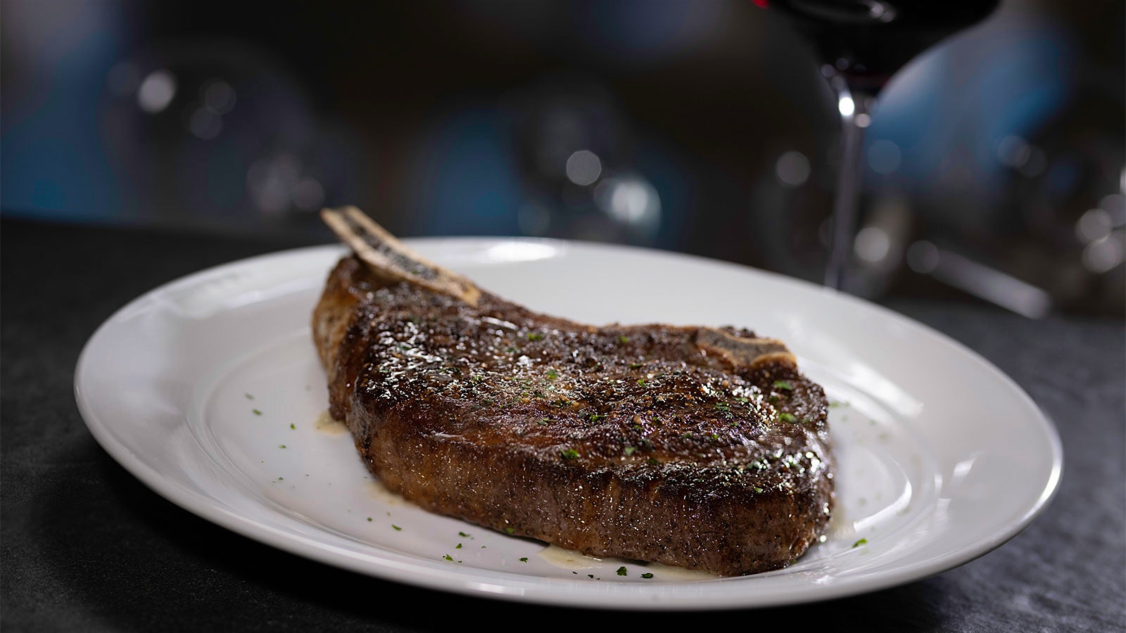  A bone-in ribeye steak on a plate at Eddie V's