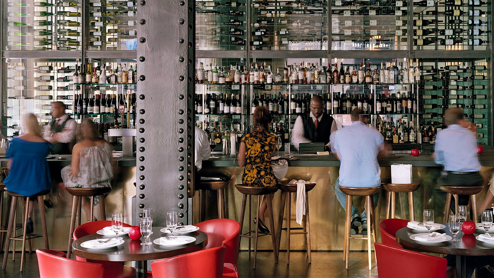  The dining room at Craftsteak, with leather chairs, wood accents and hanging lightbulb lighting fixtures