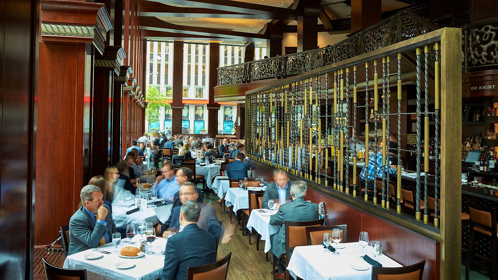  People dining in the wood-lined dining room at Del Frisco&rsquo;s Double Eagle Steak House in New York City