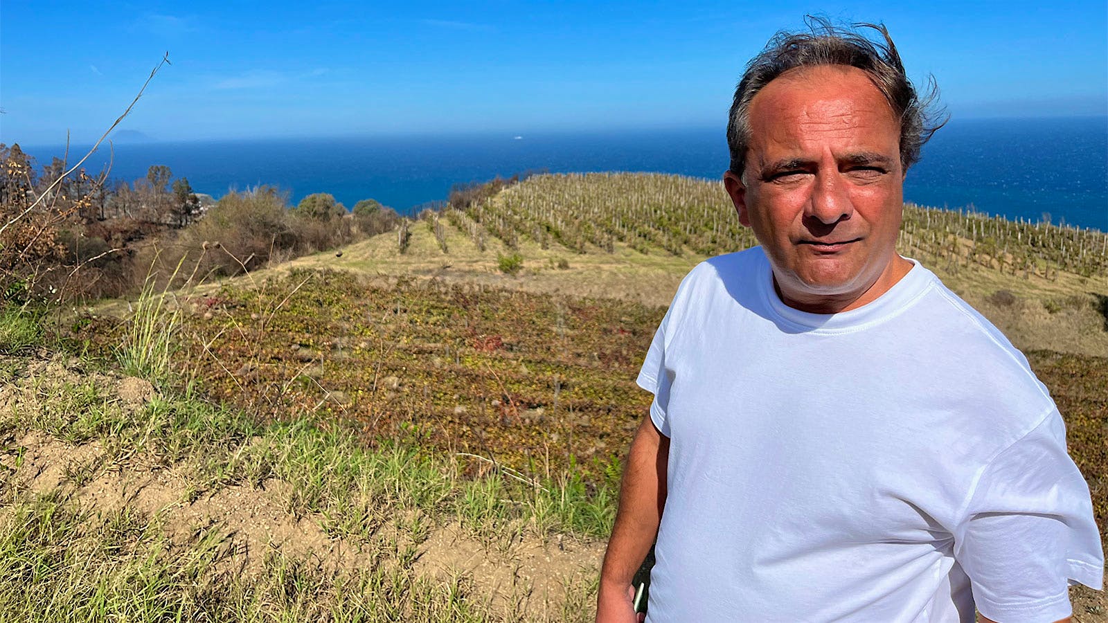 Gianfranco Sabbatino of Faro winery Le Casematte in a vineyard overlooking the Strait of Messina between Sicily and Italy