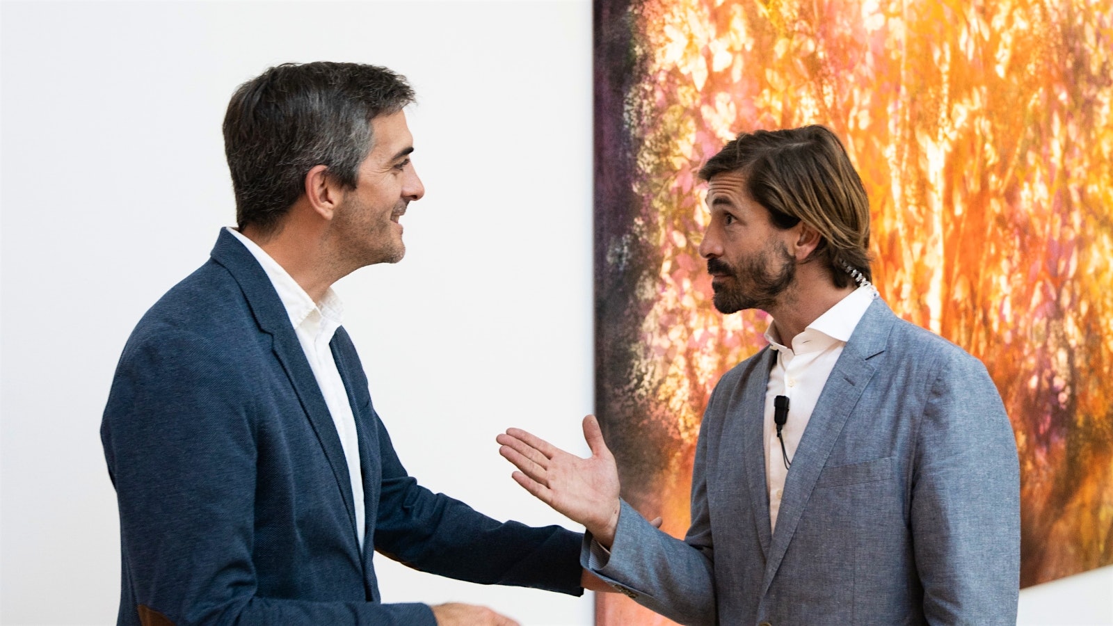  Juan and Luis Caviglia in front of a piece of modern art depicting flowers