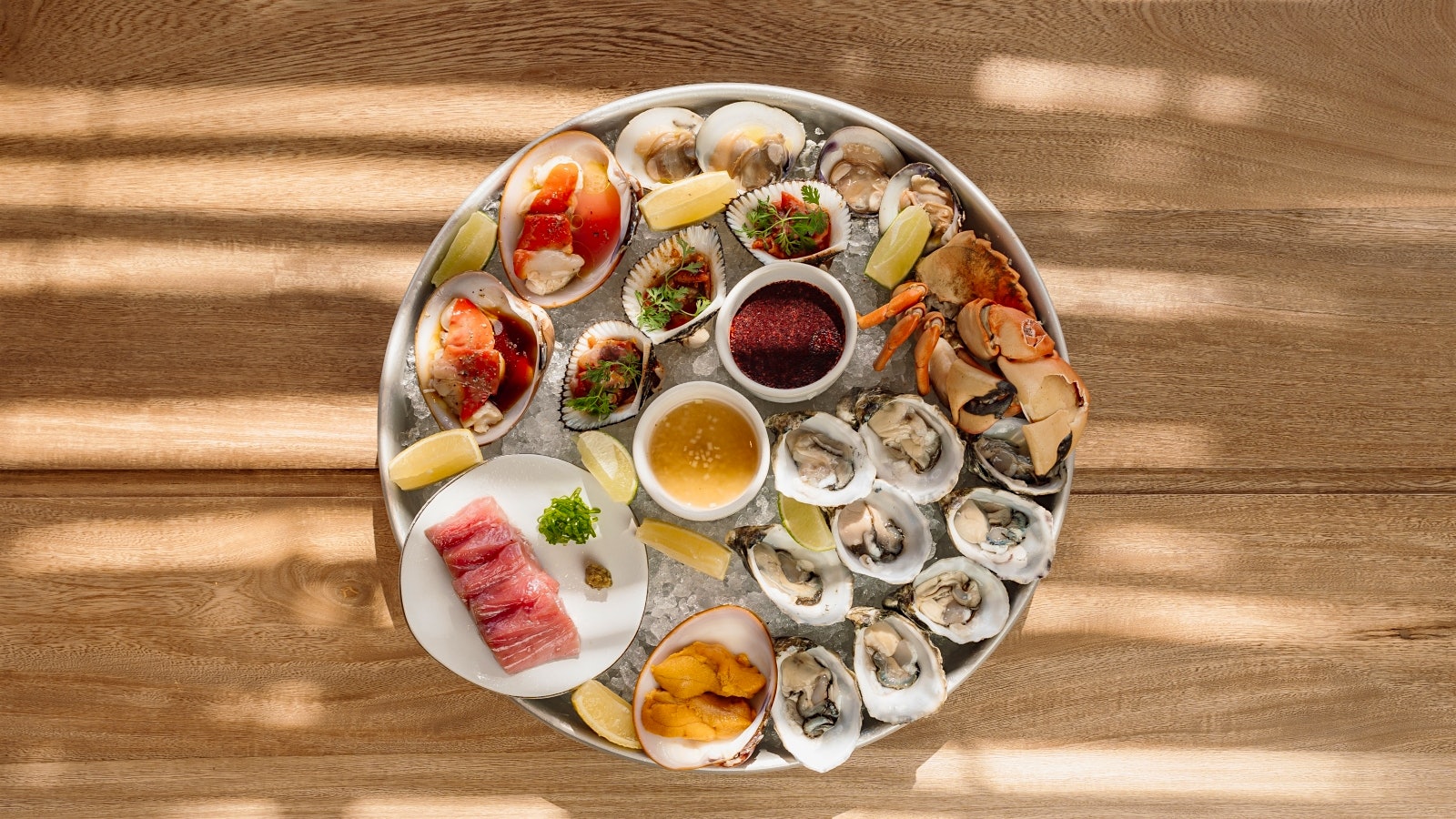  A plate of fresh oysters and other assorted shellfish on ice.