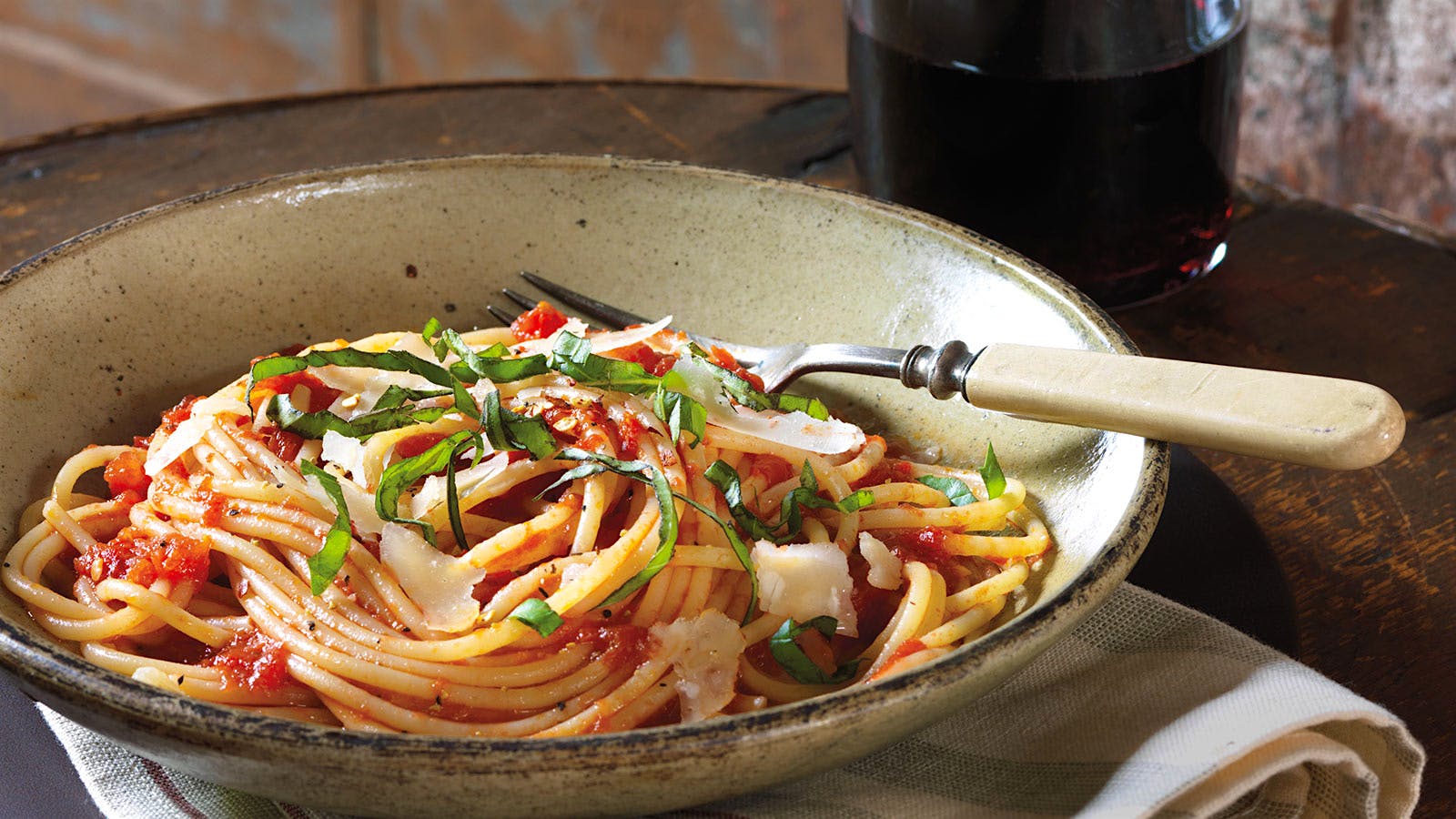 Scott Conant's spaghetti with tomato sauce and fresh basil, served with a glass of red wine