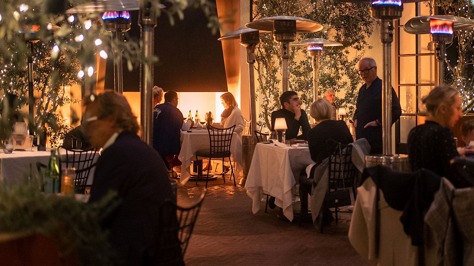 Wolfgang Puck serving guests at the terrace of Spago in Bever