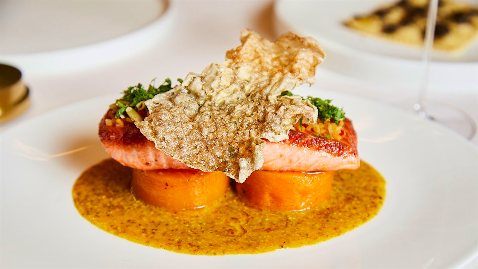  Dish of pan-roasted sea trout with pumpkin seed gremolata, butternut squash confit and brown butter–mustard sauce from Four Twenty Five in New York City