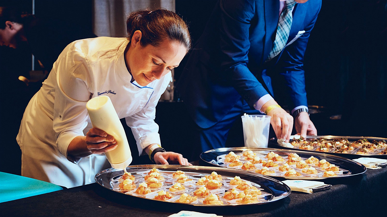  Commander’s Palace executive chef Meg Bickford finishes a shrimp dish at the Wine Spectator Grand Tour in New Orleans.