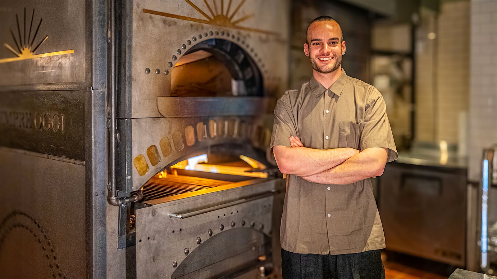  Chef Phillip Bassone in front of a wood fire oven at Sempre Oggi
