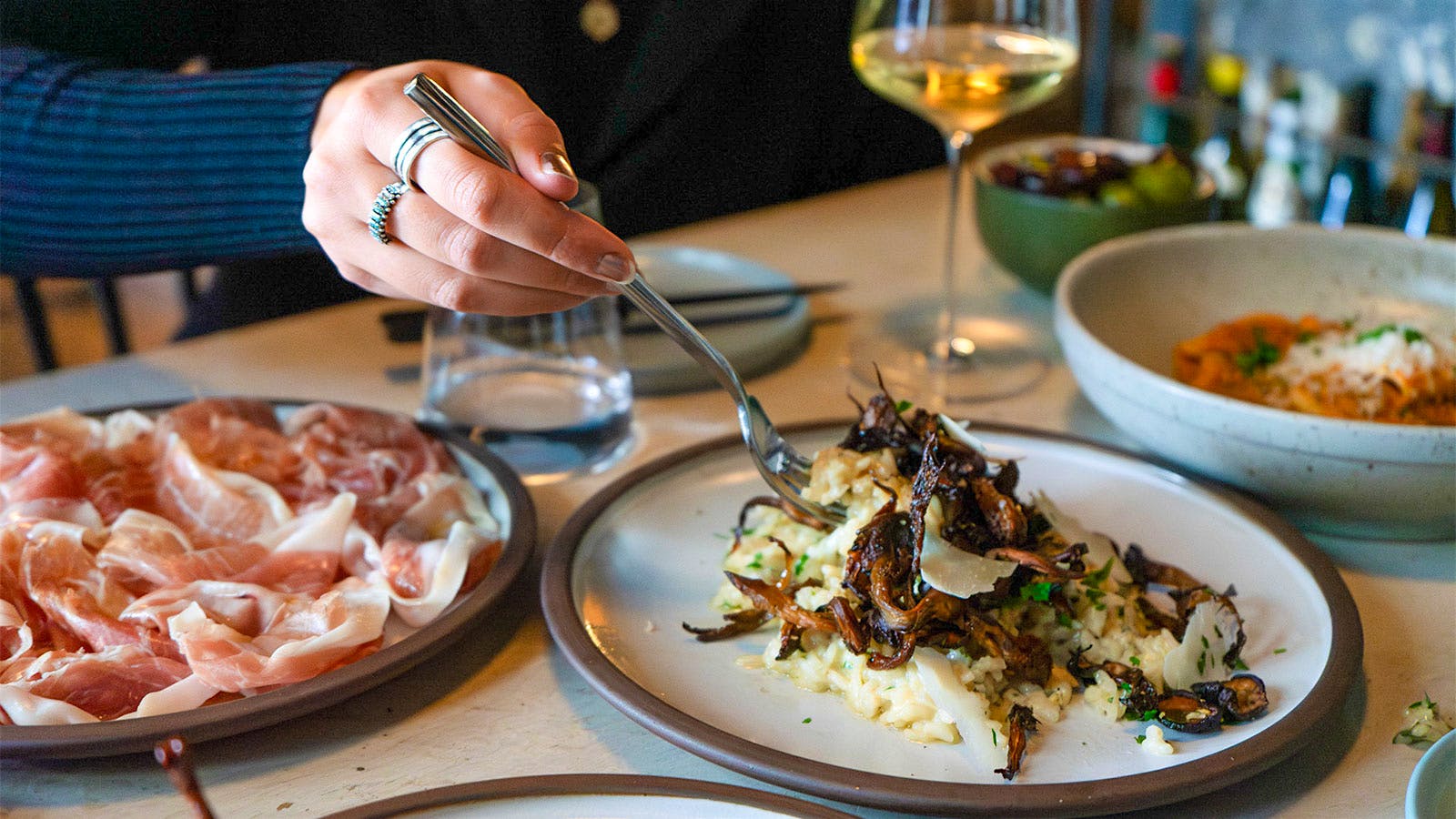 Plates of charcuterie and pasta and glasses of wine at Dedalus in Burlington, Vt.