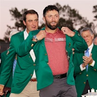 In 2023, golfer Scottie Scheffler helps Jon Rahm put on his newly earned Champion's green jacket at Augusta National. That honor also meant Rahm had to plan and pay for dinner for all the Champions in 2024.Champion Golfer Jon Rahm Turns to Spain’s CVNE Wines for Masters Club Dinner