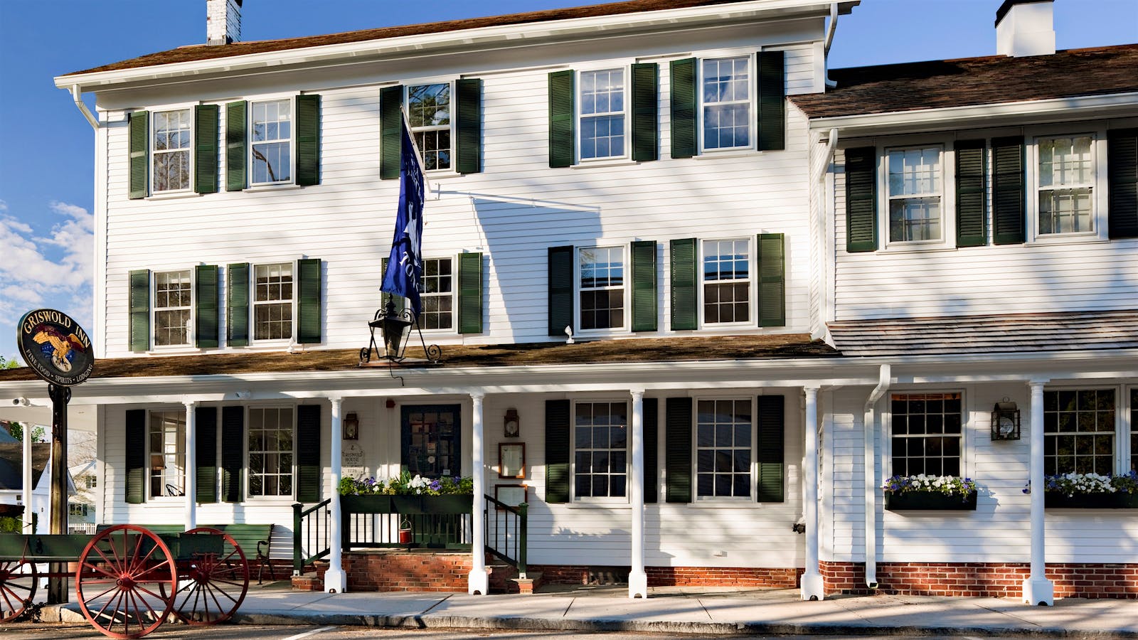 The white, Federal-style, shingled exterior of the Griswold Inn in Essex, Connecticut