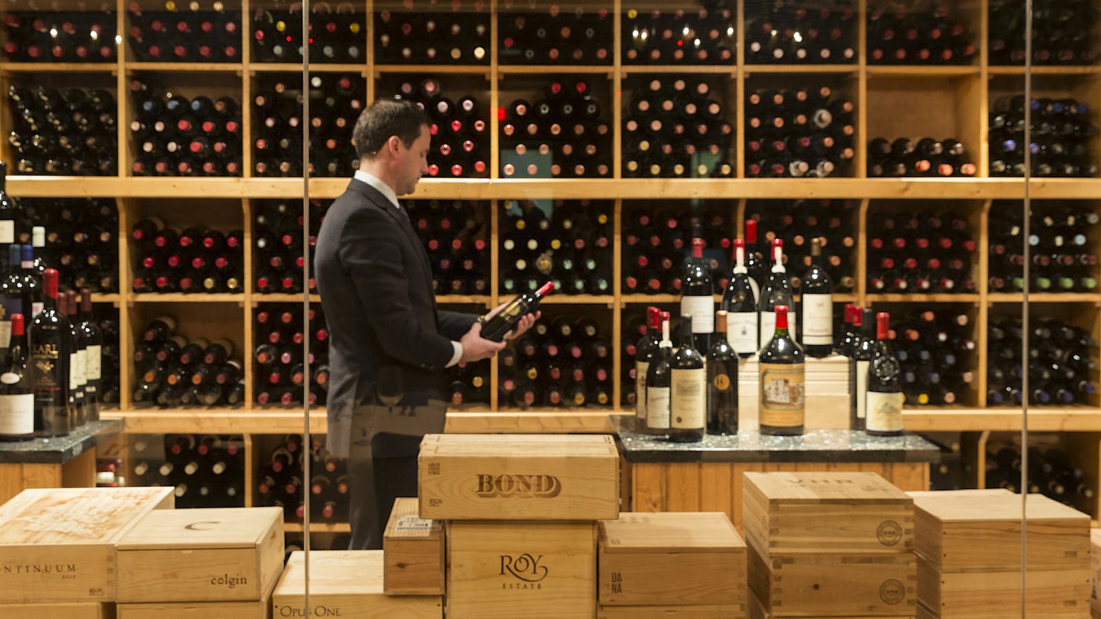 Pappas Bros. Steakhouse Downtown Houston: A sommelier selects a bottle in the impressive wine cellar