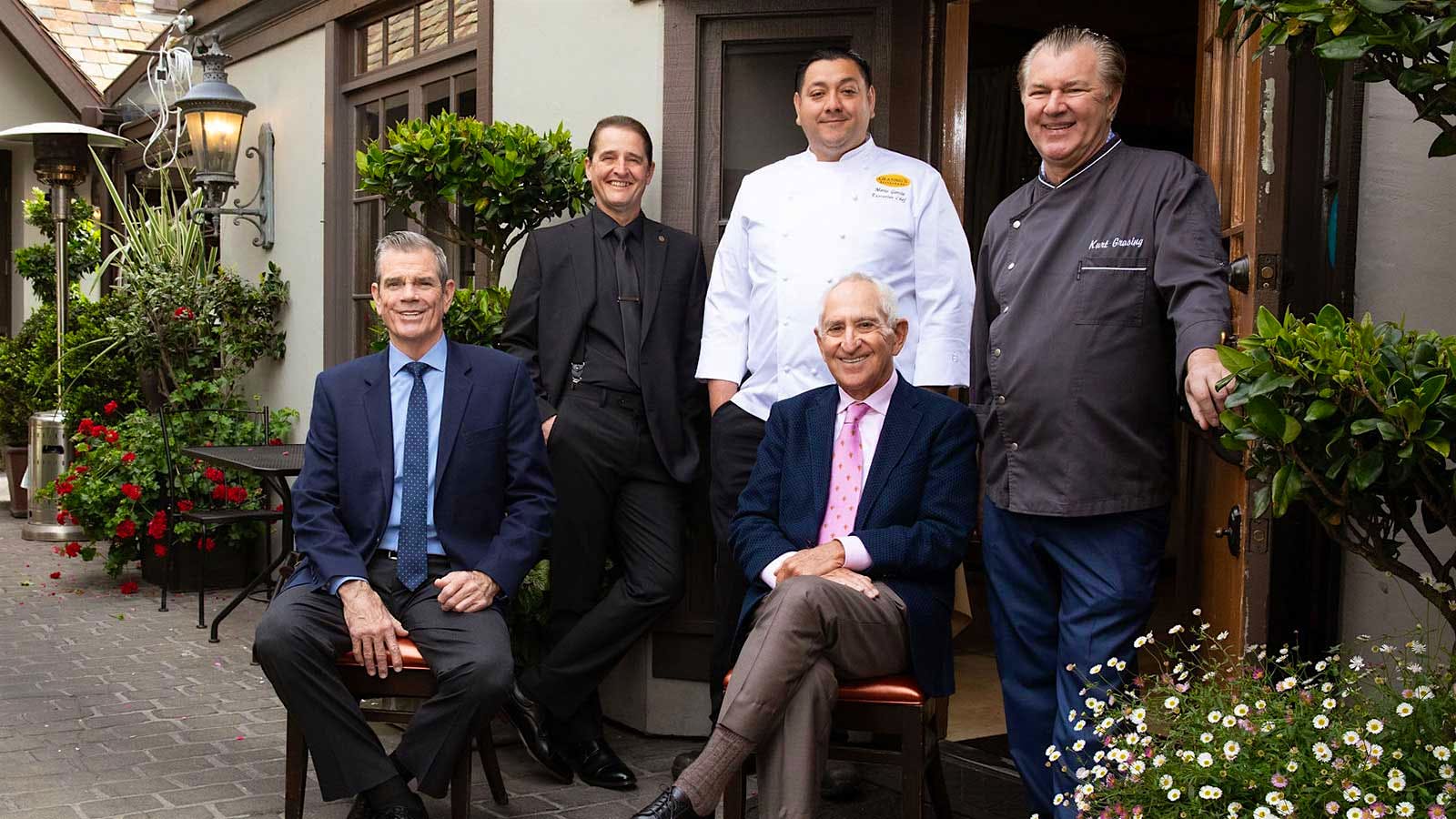 Portrait of the Grasing's team: (from left) GM Darryl Brewer, wine director Eric Ewers, executive chef Mario Garcia, owner Larry Chazen (seated center) and chef-owner Kurt Grasing