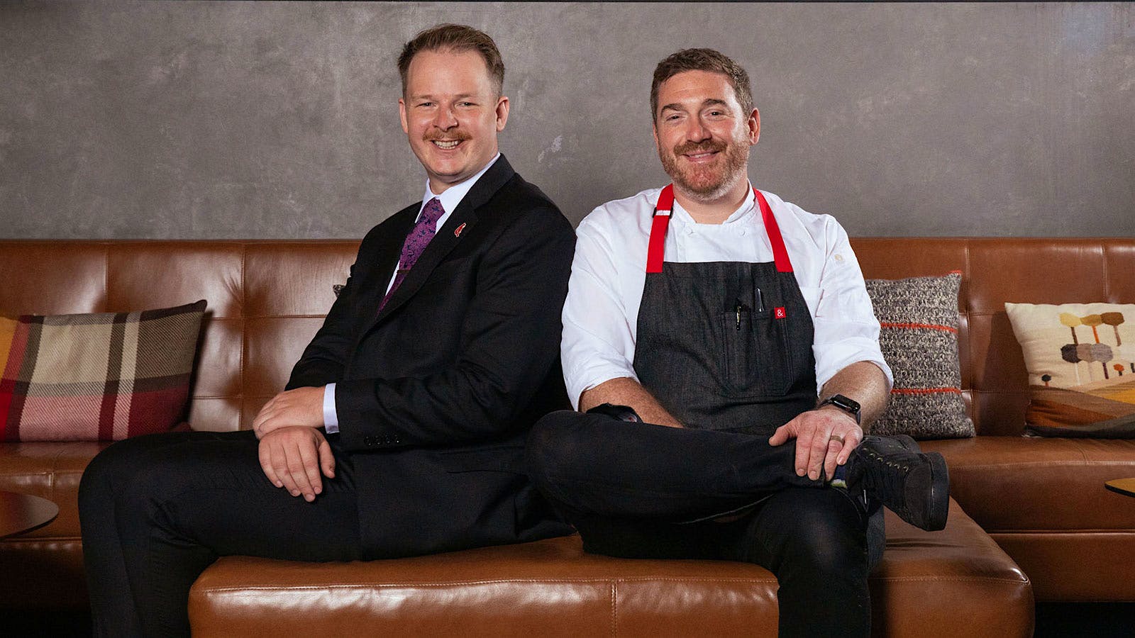 Jacob Brown and David Barzelay sit together on a banquette at Lazy Bear restaurant in San Francisco, California