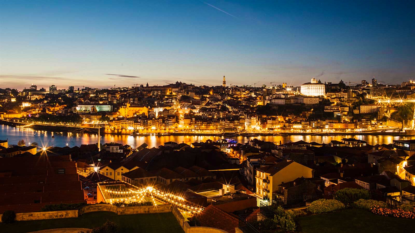  A nighttime view from The Yeatman of Porto and Vila Nova de Gaia, with lights reflecting on the Douro River