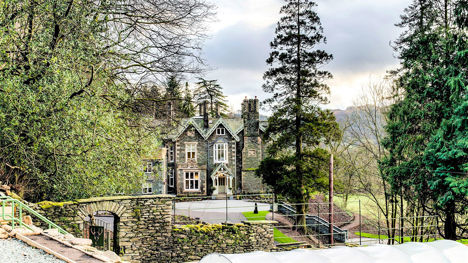 The exterior of the brick cottage of Forest Side in Grasmere, England, surrounded by forests