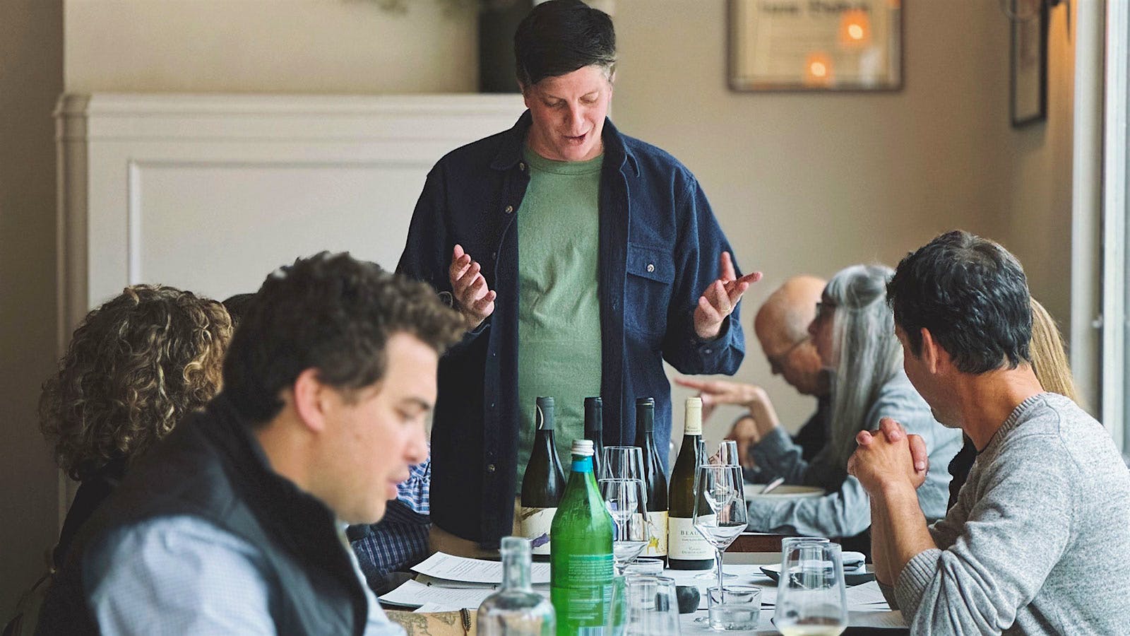  Kitchen Istanbul wine director Joseph DiGrigoli talking to a table of guests with four bottles of wine