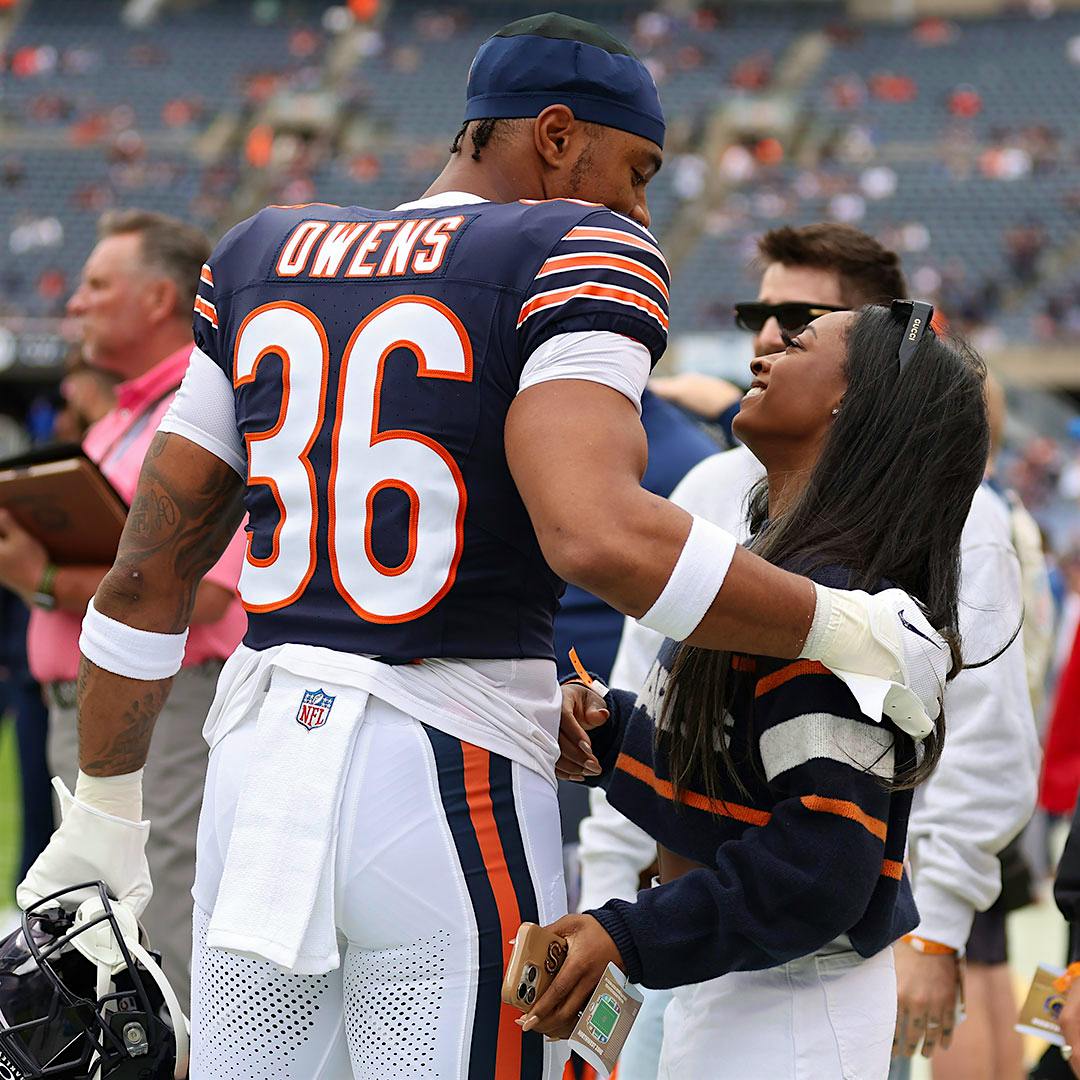 Simone Biles leaps on the balance beam during the Paris Olympics; she's invited some wine lovers to leap for joy on the sidelines of a Chicago Bears game.