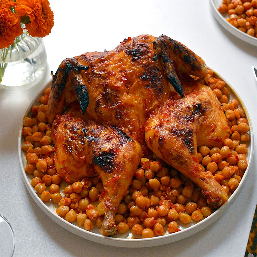 Roasting vegetables and legumes, like chickpeas, under chicken ensures that none of the flavorful schmaltz goes to waste.