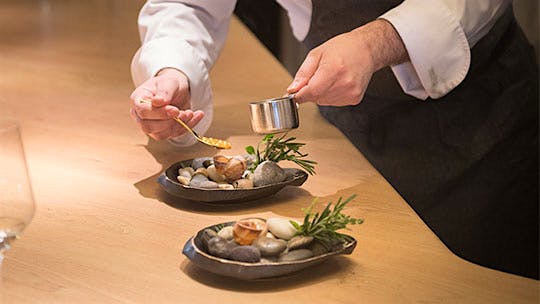 A chef preparing a dish of snails at minibar by Jos&eacute; Andr&eacute;s in Washington, D.C.