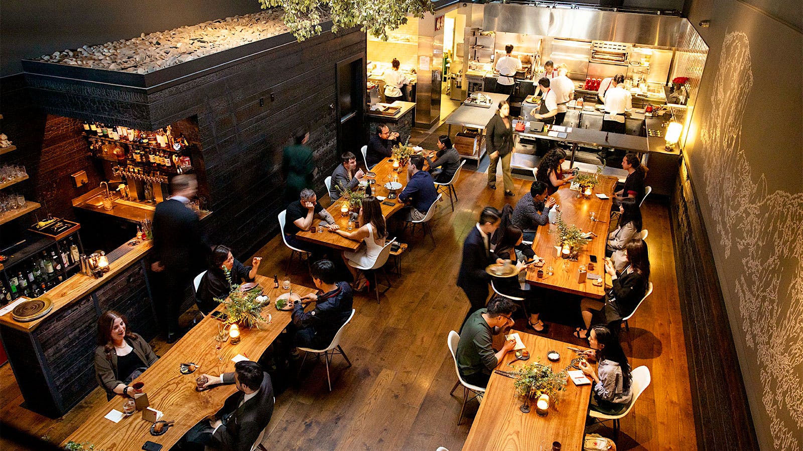  The dining room of Lazy Bear, with high ceilings and an open kitchen