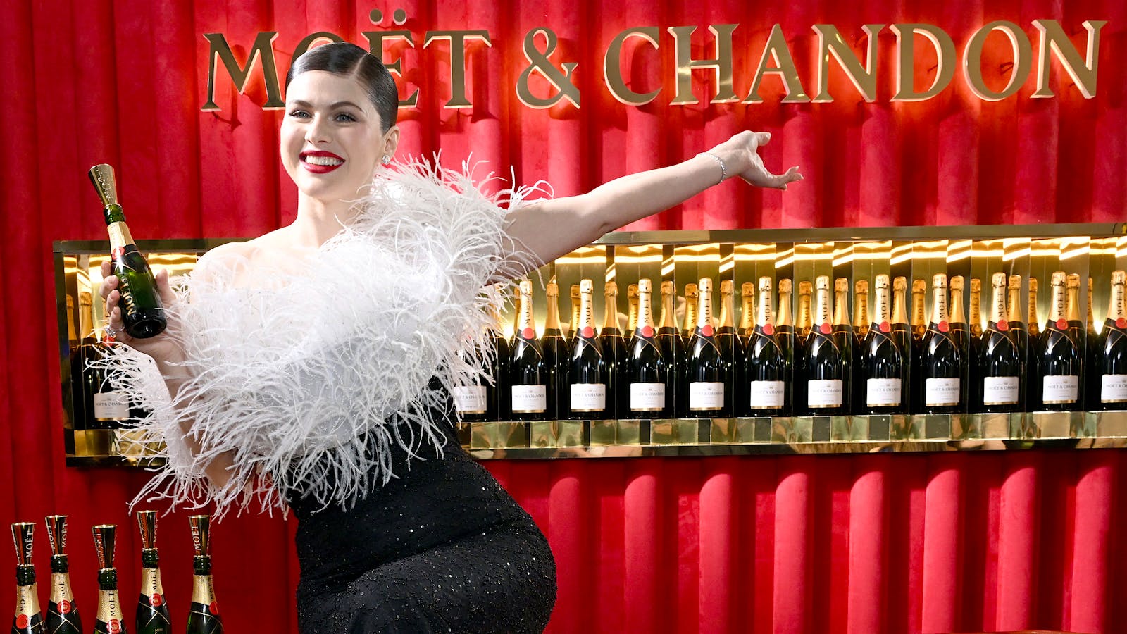  White Lotus star Alexandra Daddario at the 82nd Golden Globes Mo&euml;t &amp; Chandon bar] 