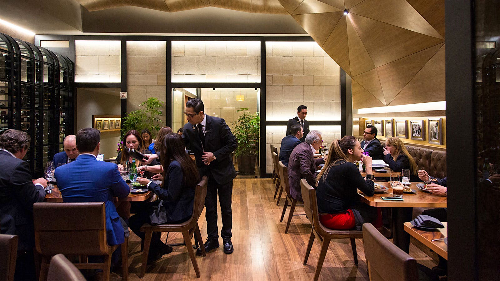  A server pouring wine for guests in the dining room of Alfredo di Roma Mexico in Mexico City.