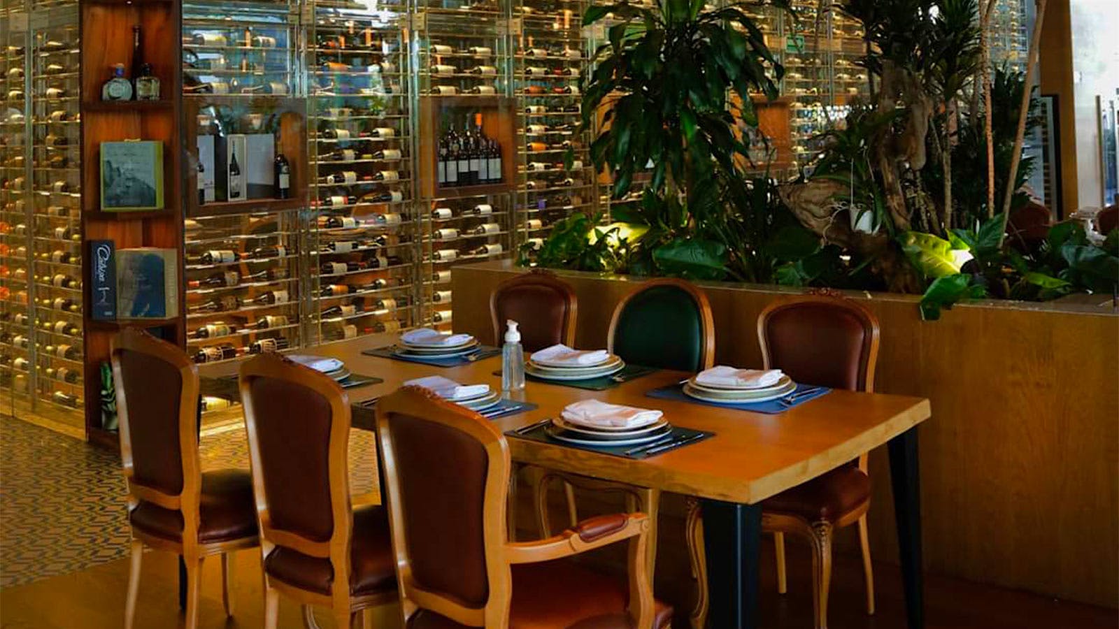 Seating and the glass-encased wine cellar at Al Andalus in Mexico City