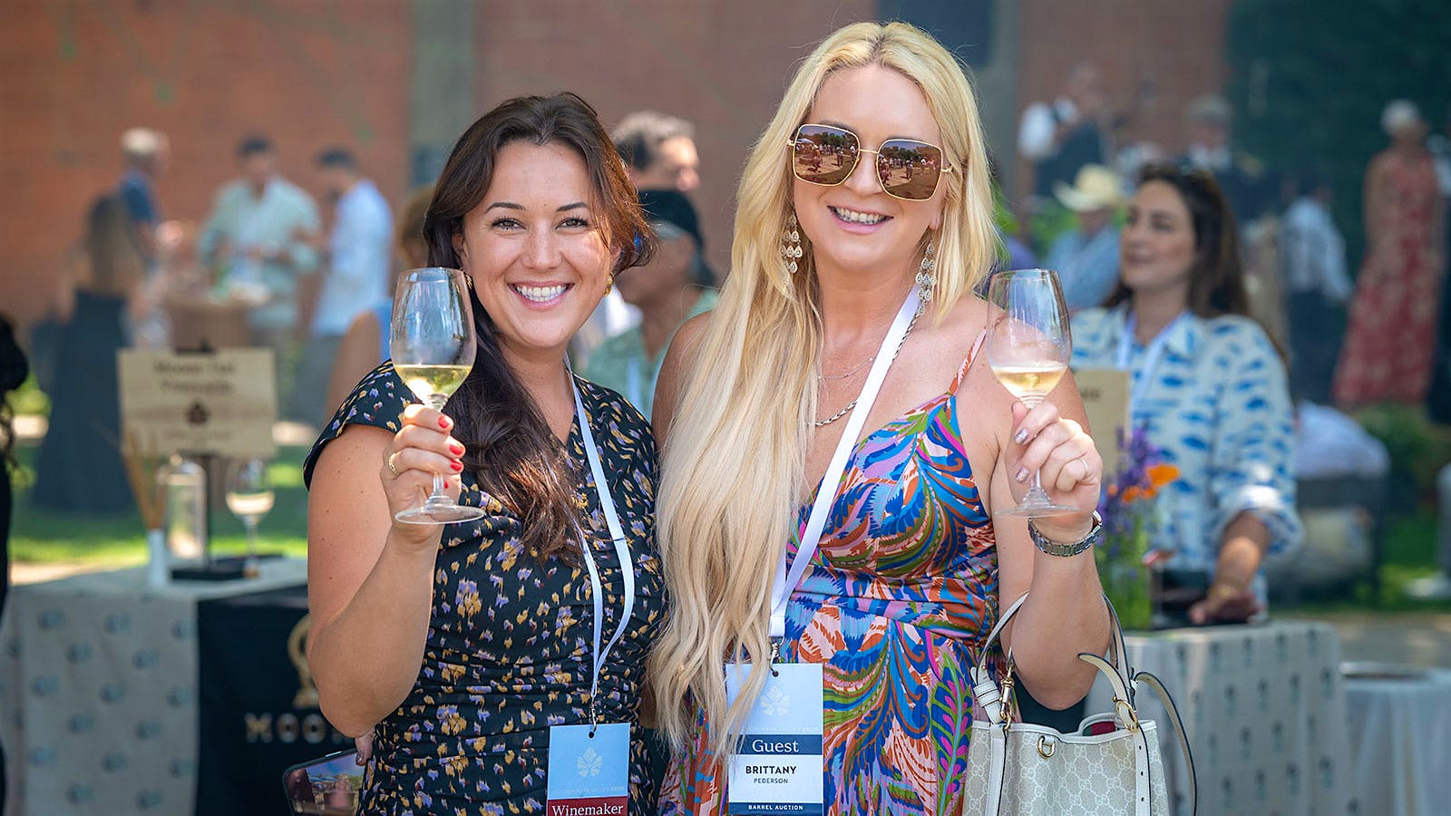  Larkmead winemaker Avery Heelan enjoying a glass of white wine at the 2025 Auction Napa Valley barrel auction with guest Brittany Pederson