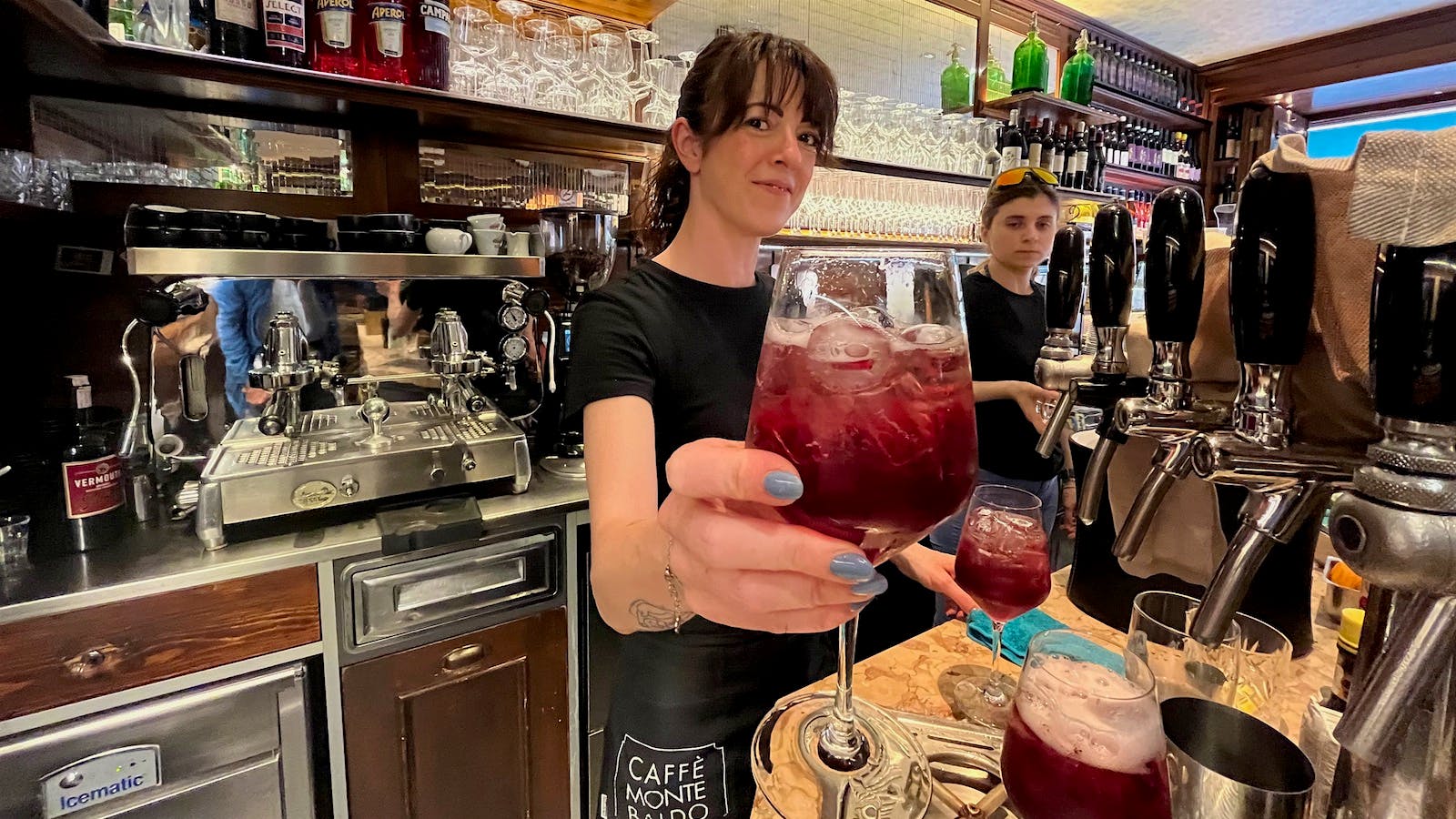  A server at Caff&egrave; Monte Baldo in Verona holds up a new Verona Spritz