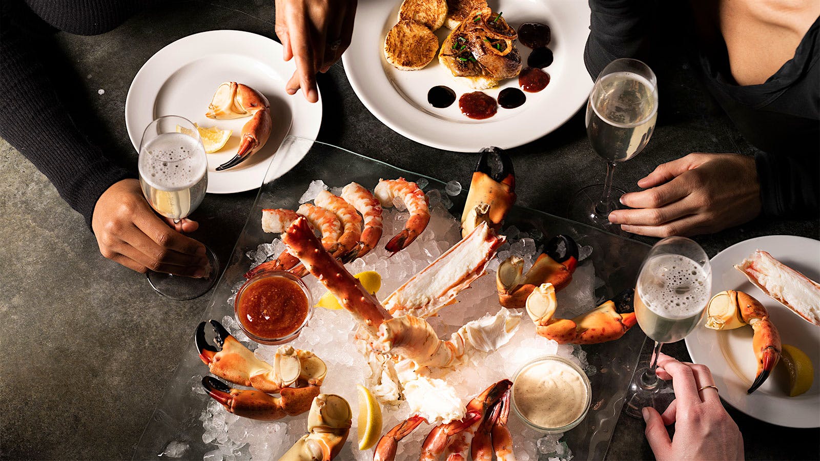  A raw bar platter served with glasses of sparkling wine from Del Frisco's Double Eagle Steakhouse