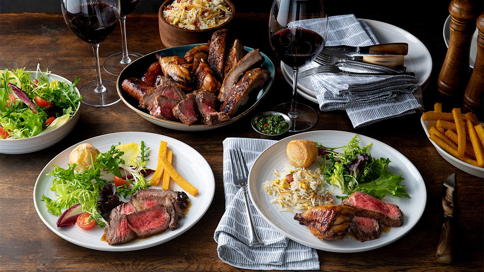 A selection of cuts of beef and glasses of red wine from Fogo de Ch&atilde;o.