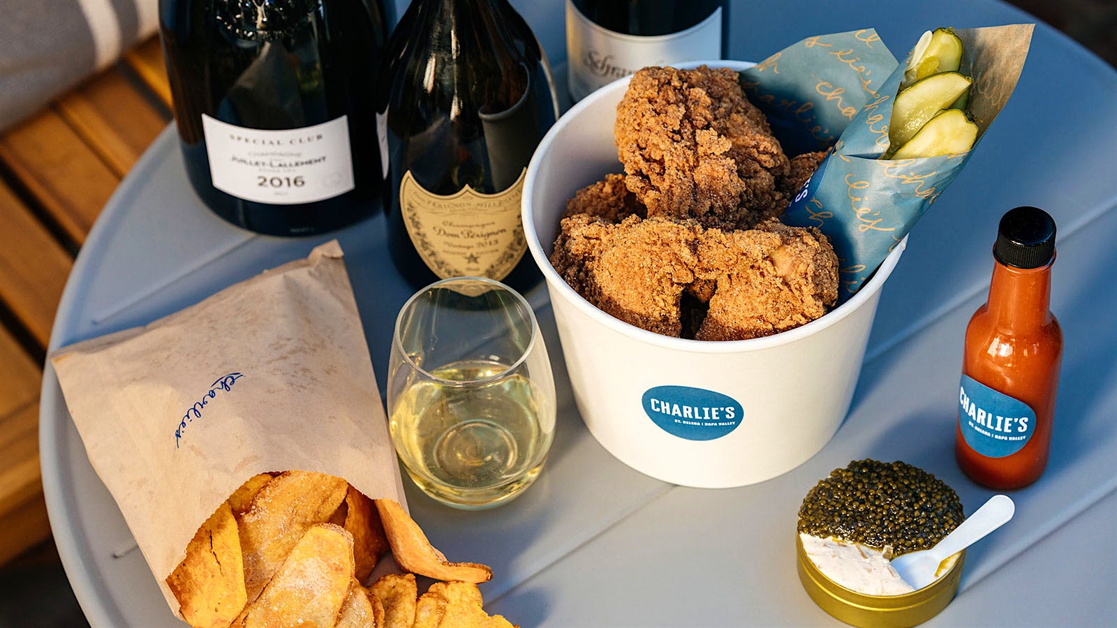  A bucket of fried chicken from Charlie&rsquo;s with caviar and several bottles of Champagne