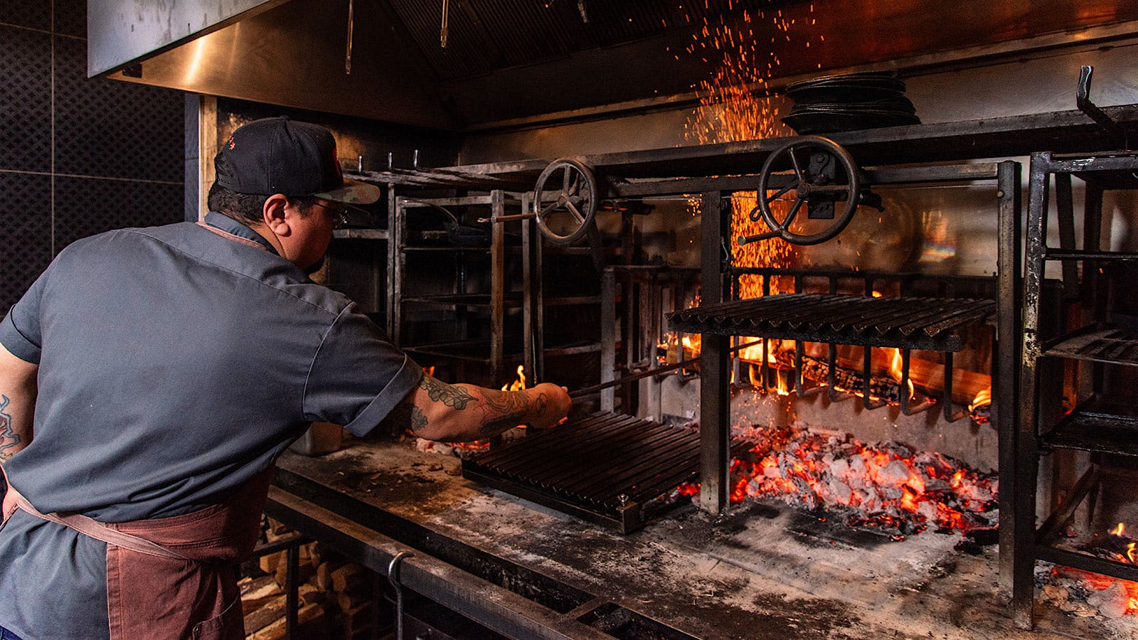  A chef grilling over a fire at El Che Steakhouse and Bar in Chicago