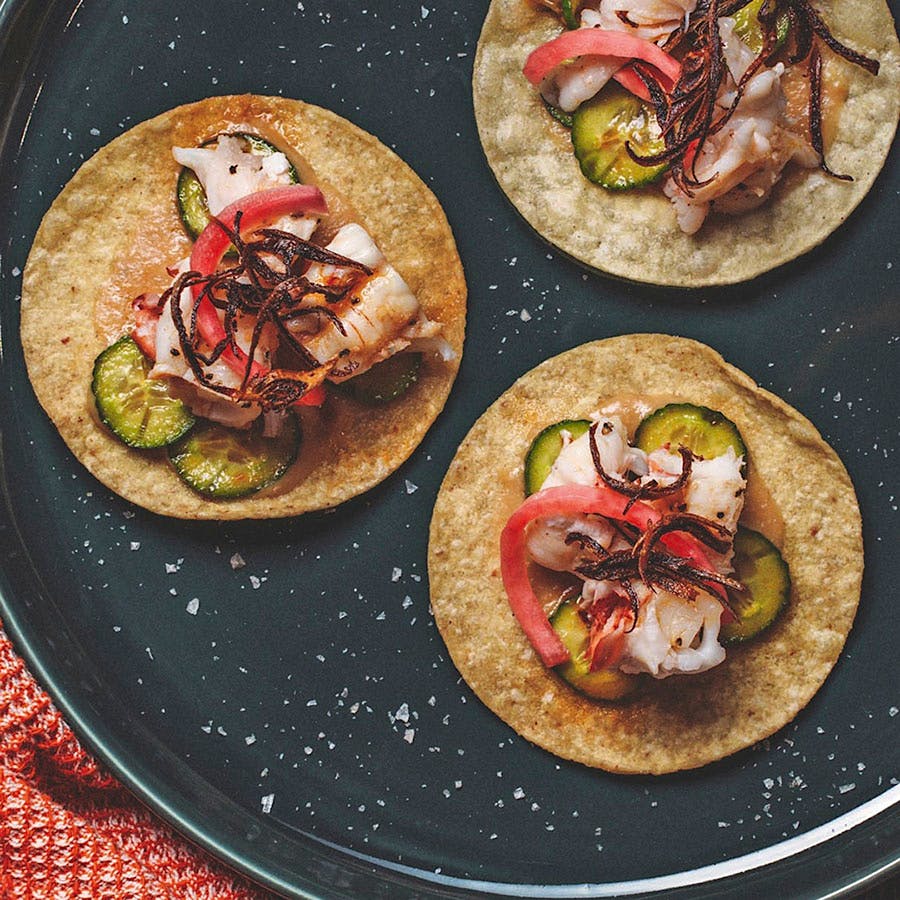 One of Hurtado's secrets to this recipe is basting the lobster tails on the grill with a compound butter of fresh tarragon, parsley, garlic, lemon, red chili and black pepper.