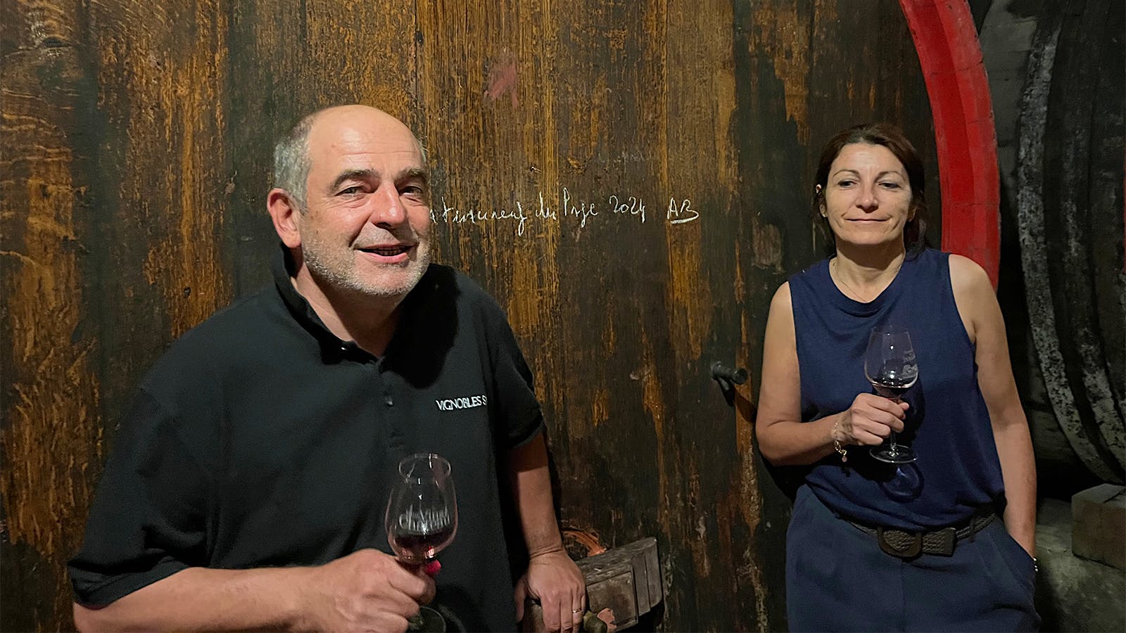  Siblings Christophe and Isabelle Sabon in front of large wood casks at Domaine de la Janasse