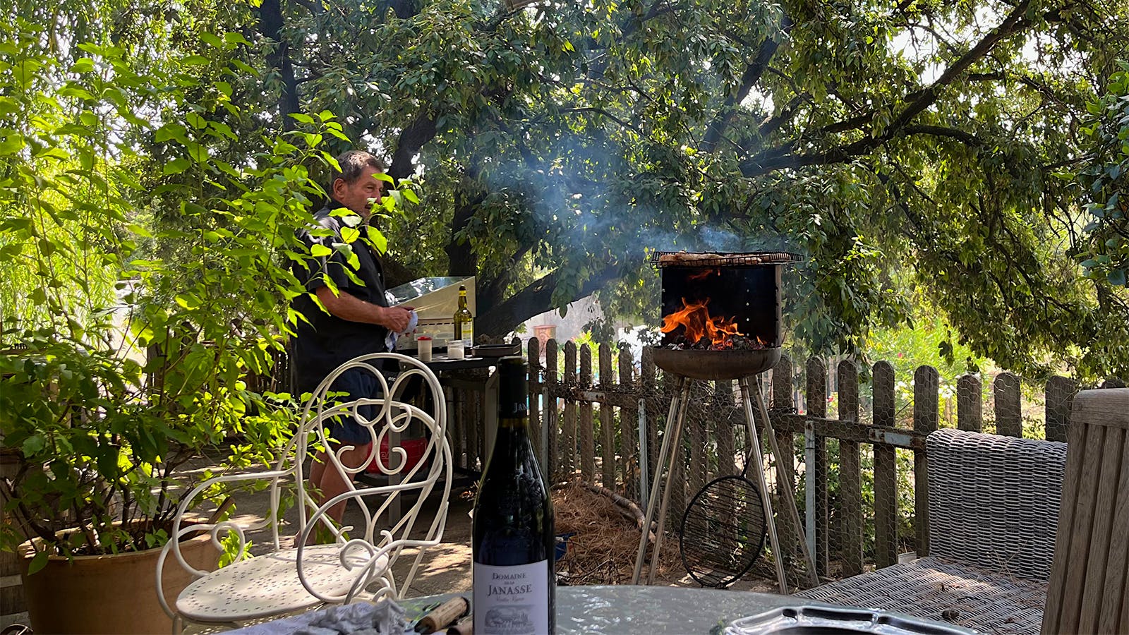  Winegrower Aim&eacute; Sabon grilling on a terrace near Domaine de la Janasse.