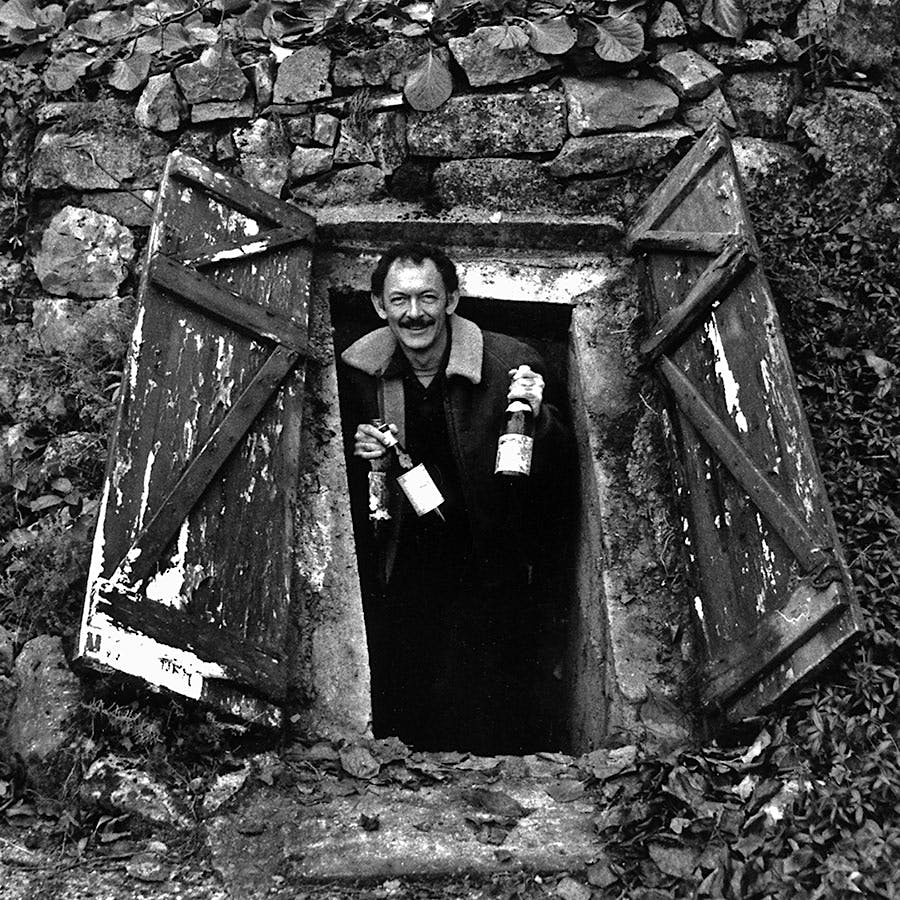  Black-and-white portrait of Kermit Lynch popping out of Richard Olney's wine cellar with a few bottles