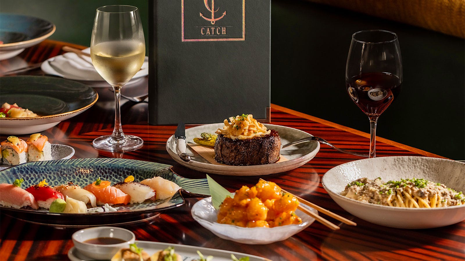 A selection of dishes, glasses of wine and the menu of Catch Scottsdale