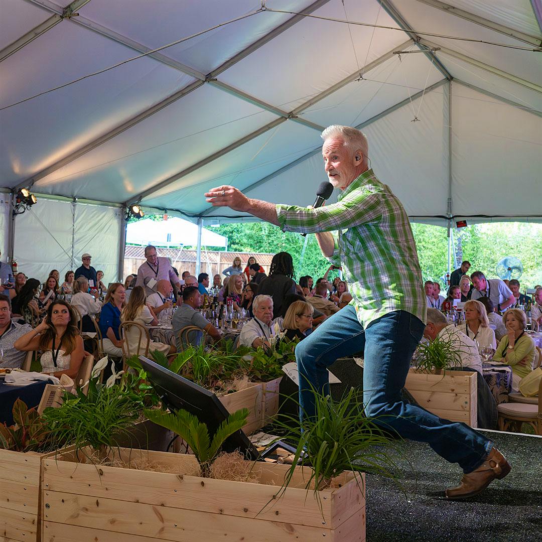 Auctioneer John Curley encouraged the crowd to bid high and support local children’s literacy programs.