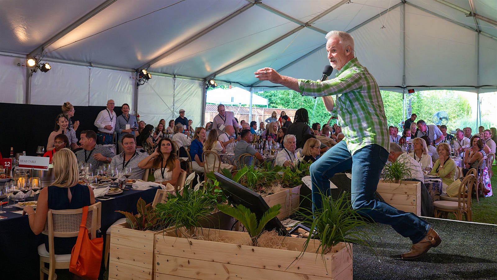 Auctioneer John Curley encouraged the crowd to bid high and support local children’s literacy programs.