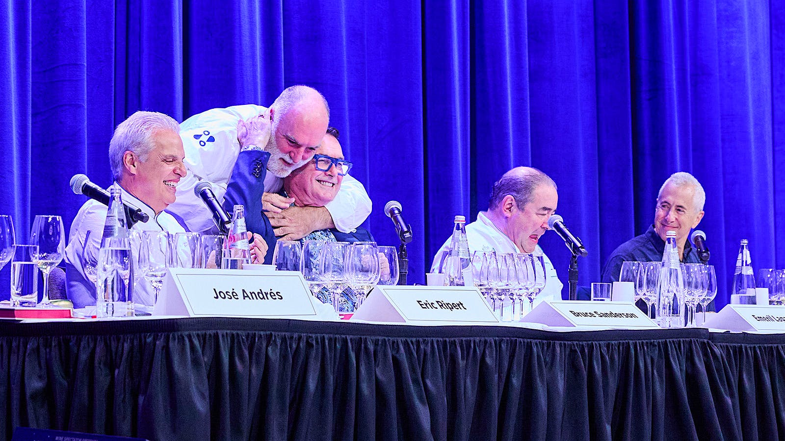  Jos&eacute; Andres hugging Bruce Sanderson (sitting center), next to from left: Eric Ripert, Danny Meyer and Emeril Lagasse