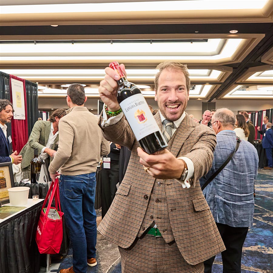  Château Langoa Barton co-owner Damien Barton-Sartorius holds up a bottle at the 2025 NY Wine Experience