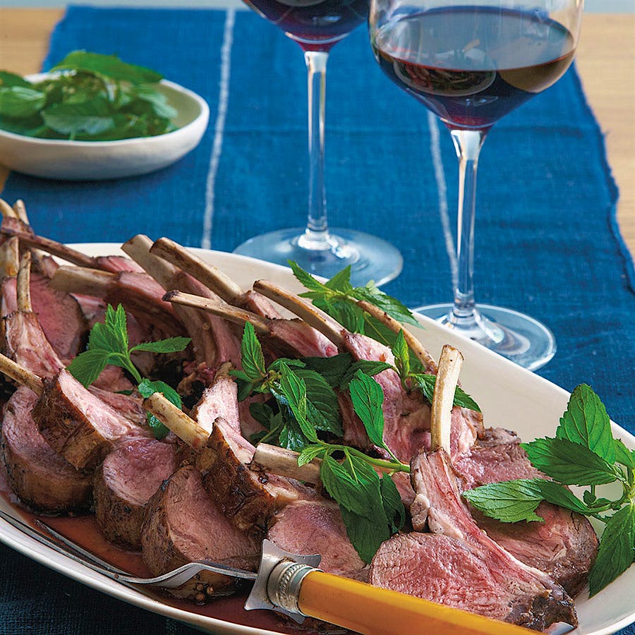  Hubert Keller's rack of lamb with toasted coriander, garnished with mint leaves and accompanied by glasses of red wine