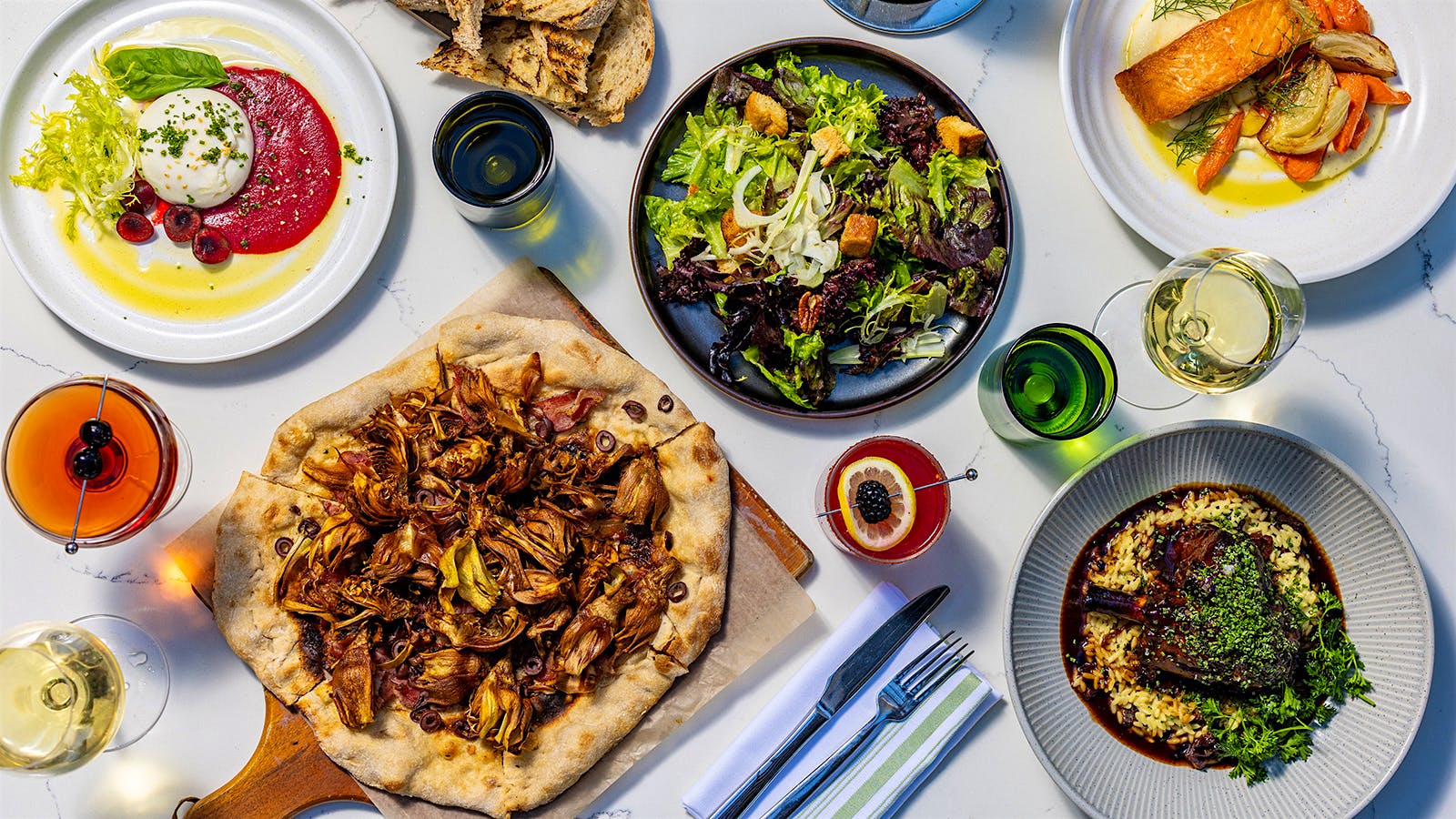 An assortment of dishes and glasses of wine from Olive and Hay in Napa Valley