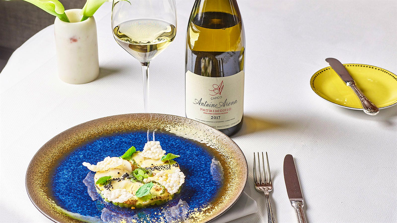 Fish dish with caviar and a bottle of white wine from Daniel