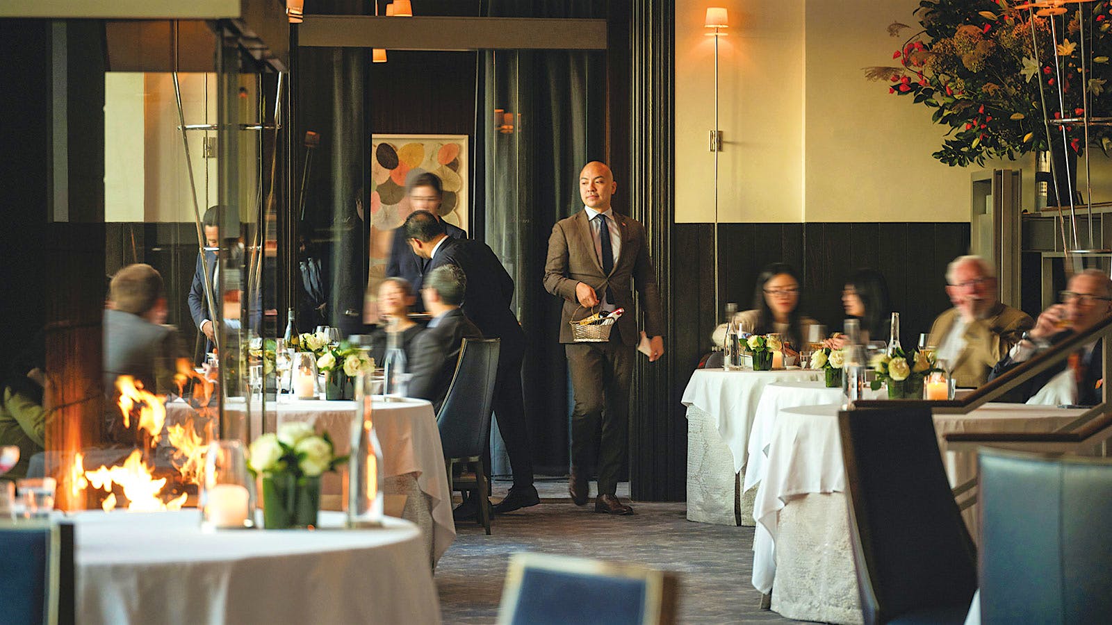  A sommelier standing in the middle of the dining room of Per Se in New York City
