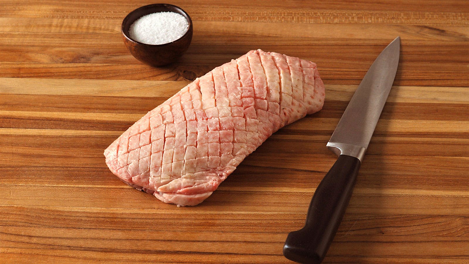  Uncooked duck breast with the fat on top scored into small diamonds