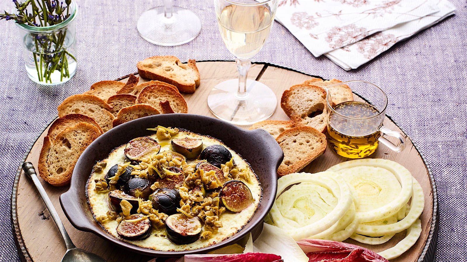  Baked goat cheese with olives and figs with a glass of Vouvray