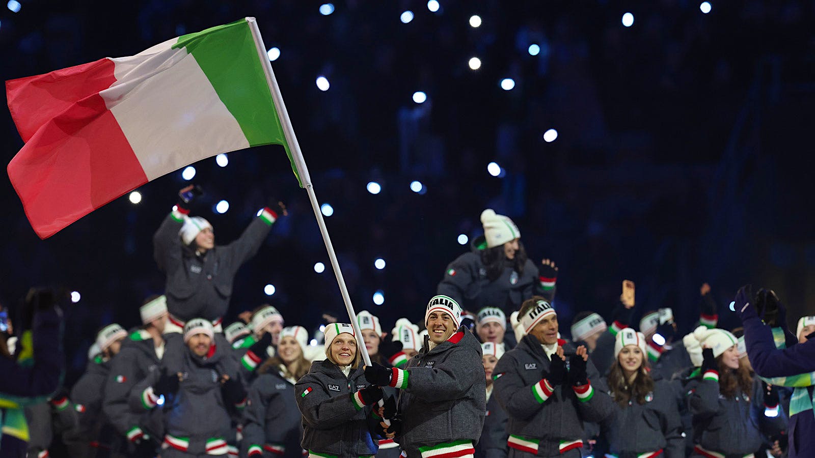 Viva Vino! The Italian athletes, the best fed in this year's Winter Games, enter the Olympic opening ceremony in Milan.