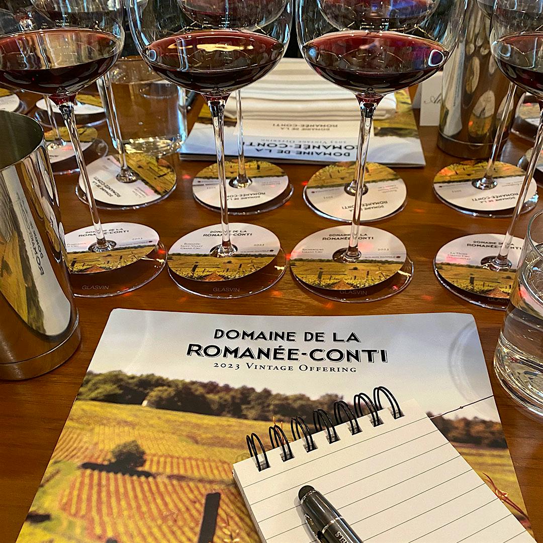  Wine glasses, spit bucket, notebook, and DRC tasting book.